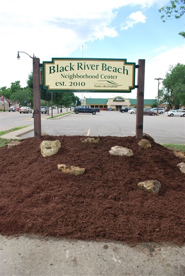 Sign for Black River Beach Neighborhood Center, established 2010, with City of La Crosse Parks & Recreation logo.