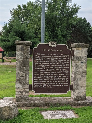 Red Cloud Park historical marker detailing the life and heroism of Corporal Mitchell Red Cloud Jr., a Winnebago descendant who received the Congressional Medal of Honor posthumously for his actions in Korea.