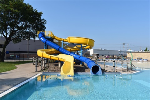 waterslides at Erickson Pool. one yellow, open, and curvy slide. one blue, enclosed, curvy slide. 