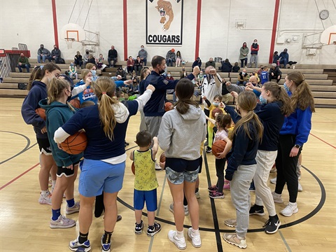 youth basketball team in a huddle 
