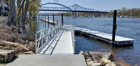 Gangway to transient dock on riverfront with Cass St. bridge in background