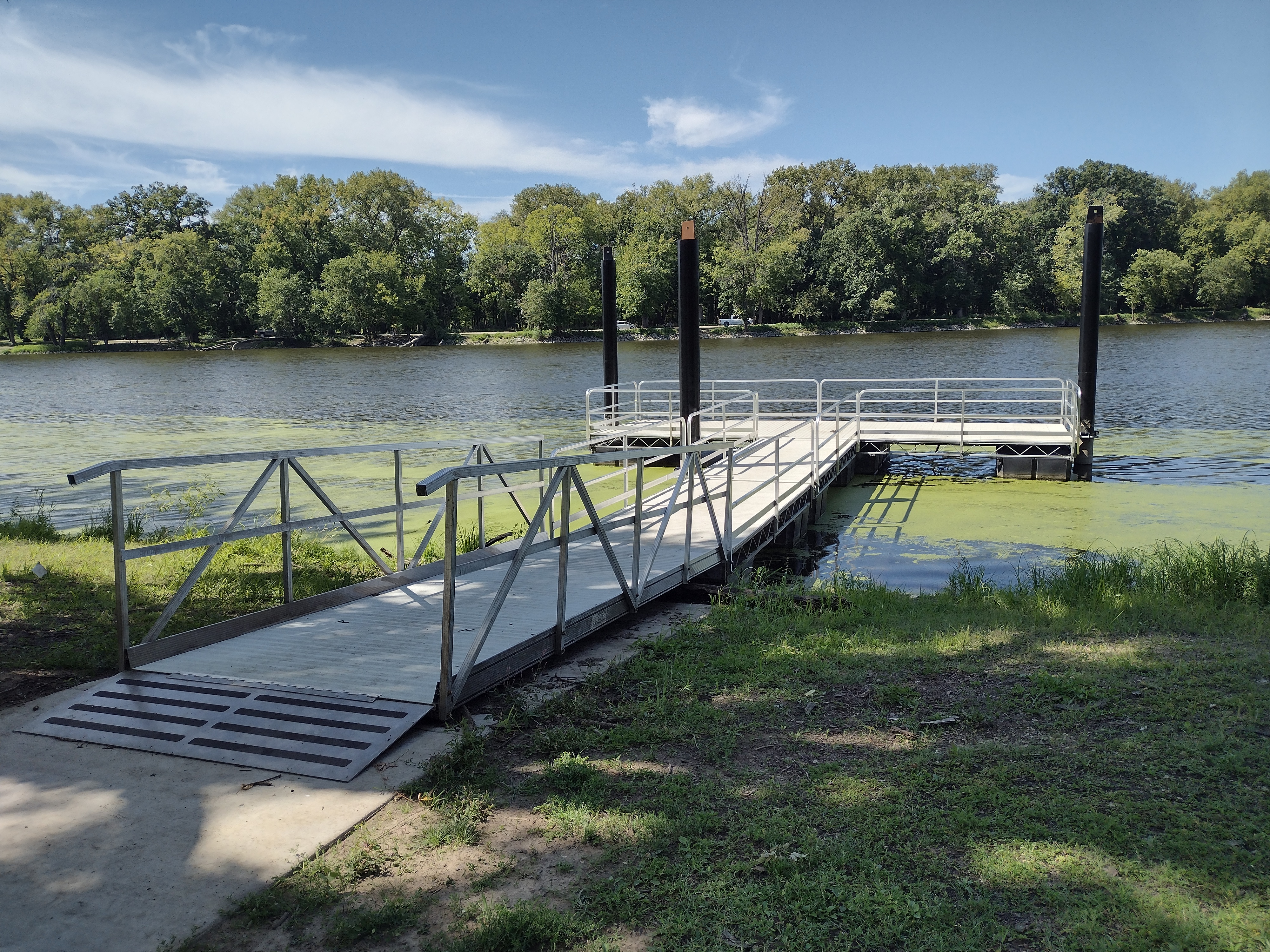 Gangway to accessible fishing pier on lagoon bank