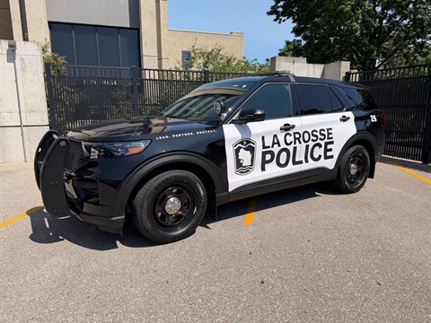 Black and white La Crosse Police SUV parked in front of City Hall.