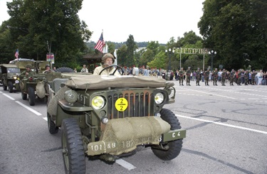 Old fashioned military tank vehicle driving in a parade